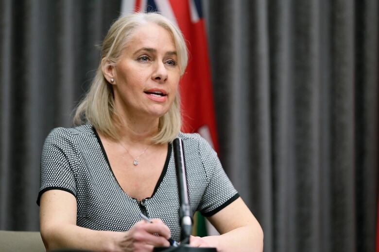 A woman speaks at a news conference.