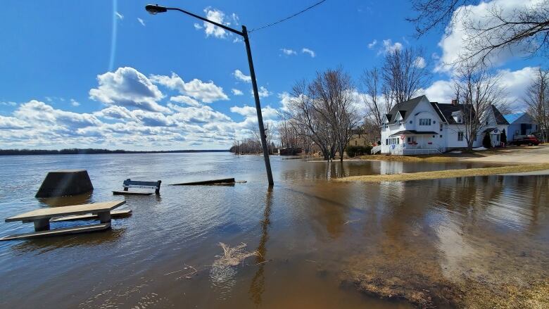 A house surrounded by a flooded yard