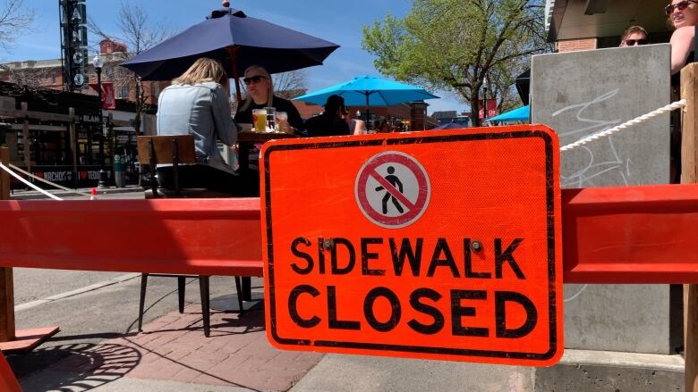 A sidewalk closed sign. 