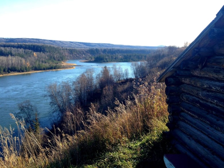 A river flows behind a small structure.