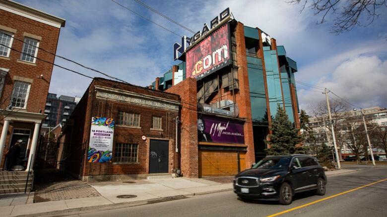 A brick and glass building is shown in downtown Toronto.