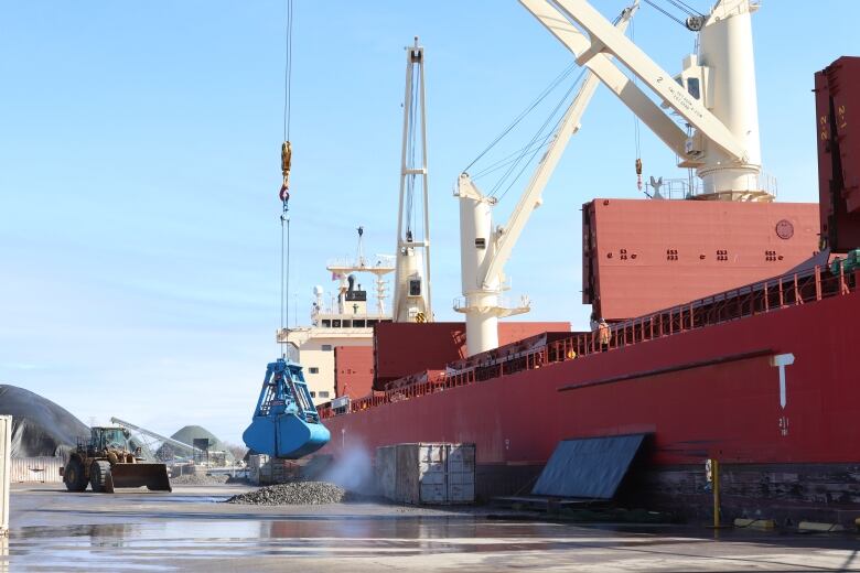 A large ship is docked at a pier.