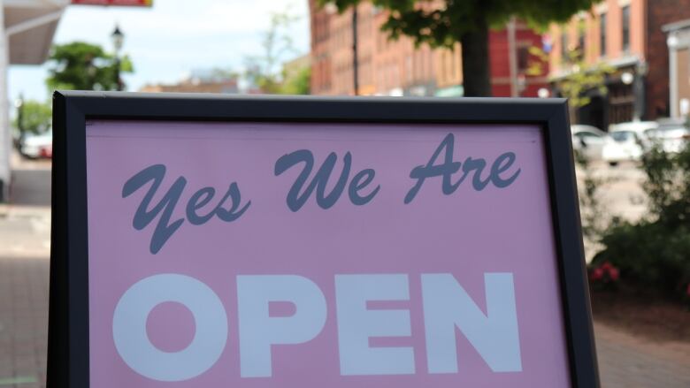 A sign outside a shop that reads 