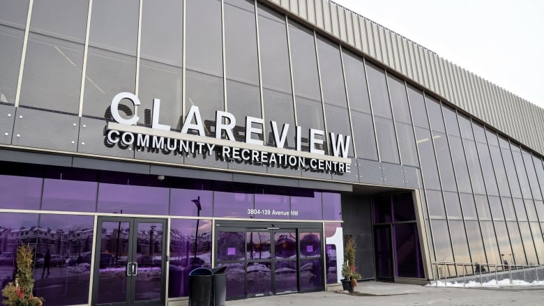 Clareview Community Recreation Centre has walls of grey tinted windows and purple tinted glass doors. 