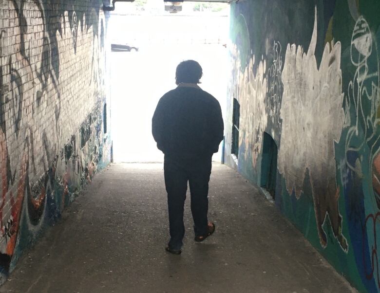 Man walking down alley way