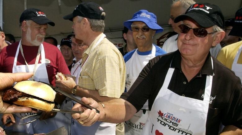 Men in aprons at barbecue