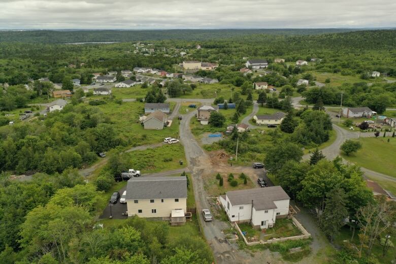 An overhead view of part of North Preston shows green trees, roads and homes