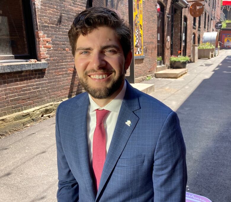 Man standing and smiling at camera.