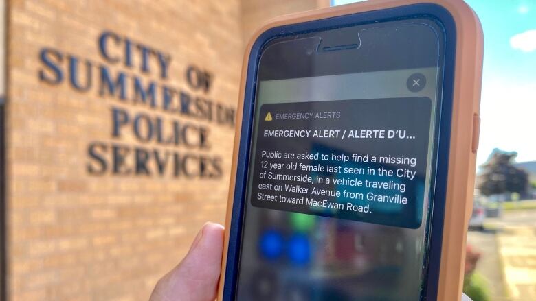 A close up of a phone showing an emergency alert. 