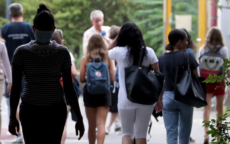 Students with backpacks walking outside.