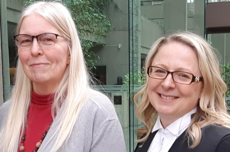 Rosemary Anderson, left, stands outside the Vancouver law courts with her lawyer, Sandra Kovacs, in March 2020 at the conclusion of the civil trial over her abuse at the hands of a Catholic priest.