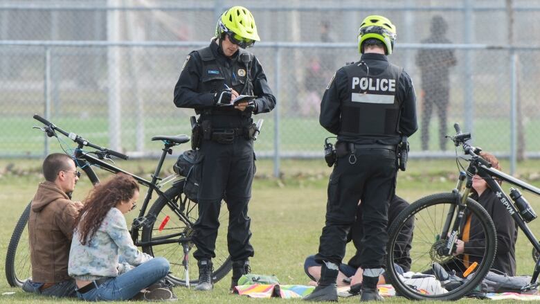 Two Montreal police officers patrol in a park in Montreal 