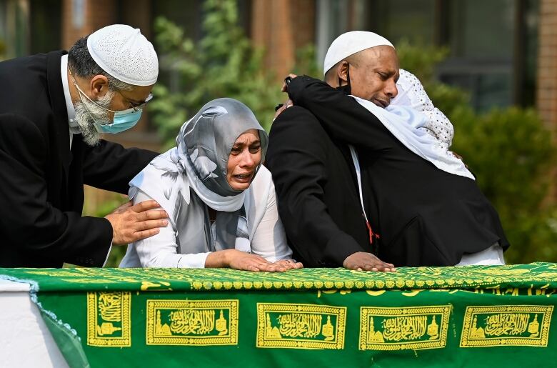 Daughter Bebe Zafis, second left, and family members react at her fathers casket during the funeral of Mohamed-Aslim Zafis in Toronto on Wednesday, September 16, 2020. Police say Zafis was fatally stabbed by an unknown suspect while he sat outside the mosque as he controlled entry to the building in order to comply with public health protocols.