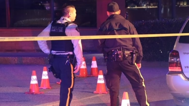 2 police officers standing in front of crime scene