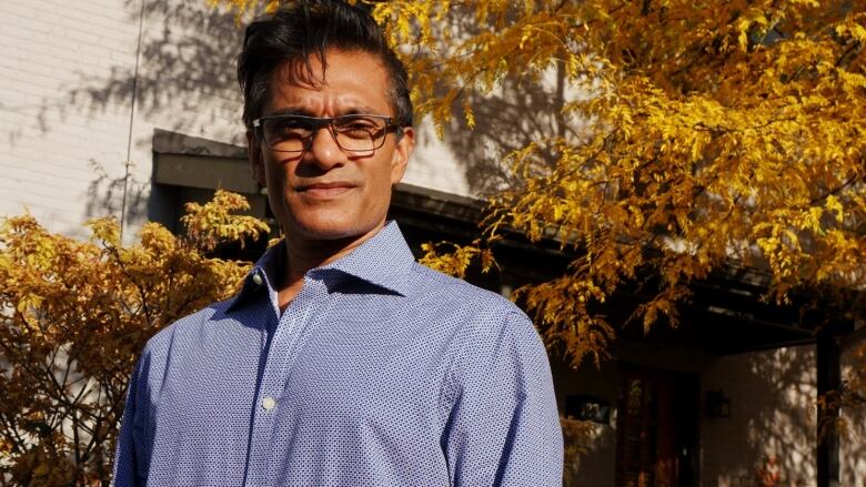 An epidemiologist poses for a photo outside on an early autumn day.