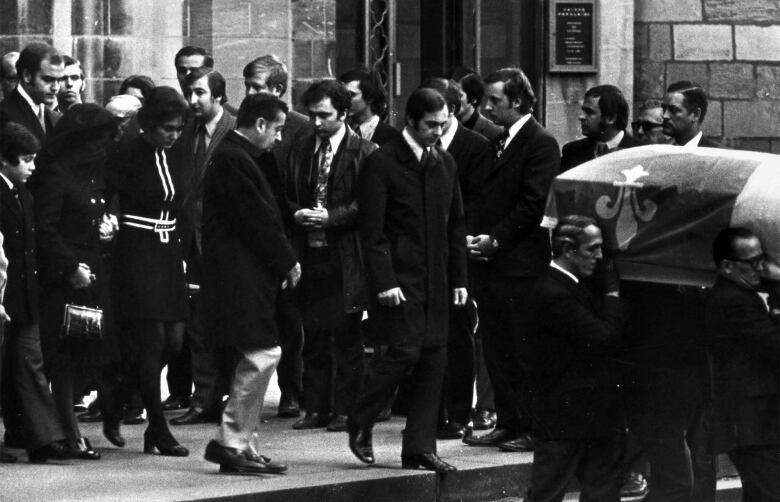 Mrs. Pierre Laporte being escorted by family after funeral services