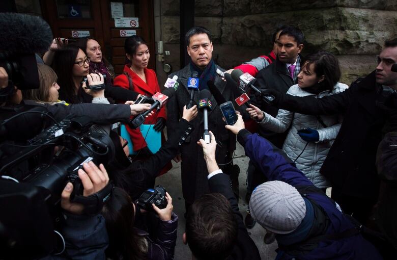 John Lee, lawyer for Qing Quentin Huang, speaks outside of the courthouse after Huang's bail hearing was put off until a later date in Toronto, Wednesday, December 4, 2013.