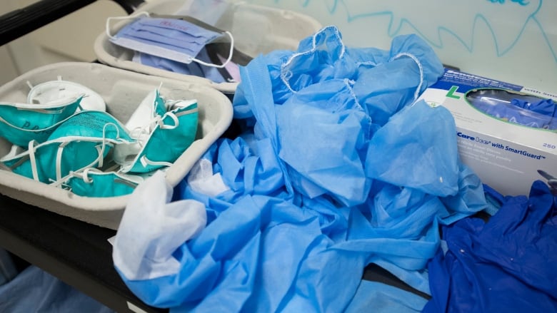 A pile of blue masks and hospital gloves. 