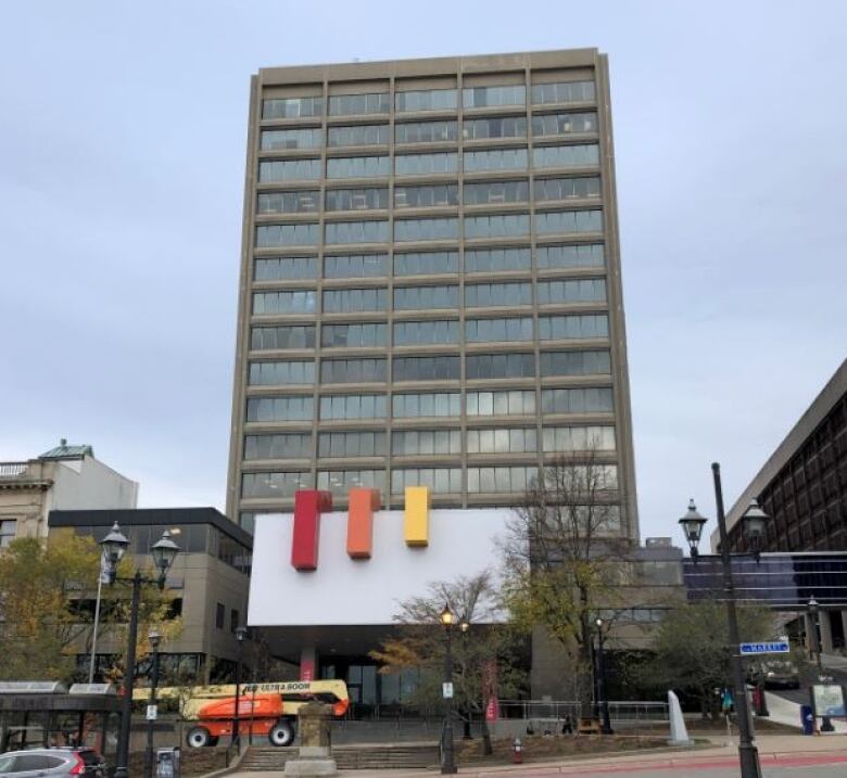 A photo of the outside of a tall commercial building, consisting mostly of rectangular windows. 