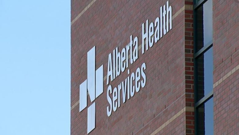 An Alberta Health Services sign is seen on a building.