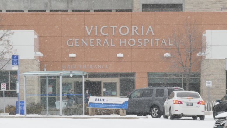 The exterior of a building with a sign reading Victoria General Hospital Main Entrance.