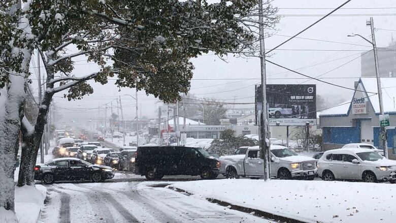 This picture shows heavy traffic and snowy roads. 