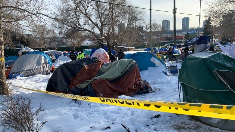 Tents dot a plot of snowy land near downtown Edmonton. 