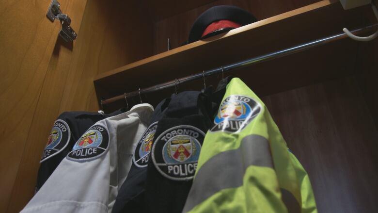 A Toronto police officer's uniform hanging in a closet.