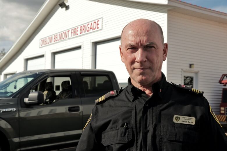 A man is shown standing outside a building.