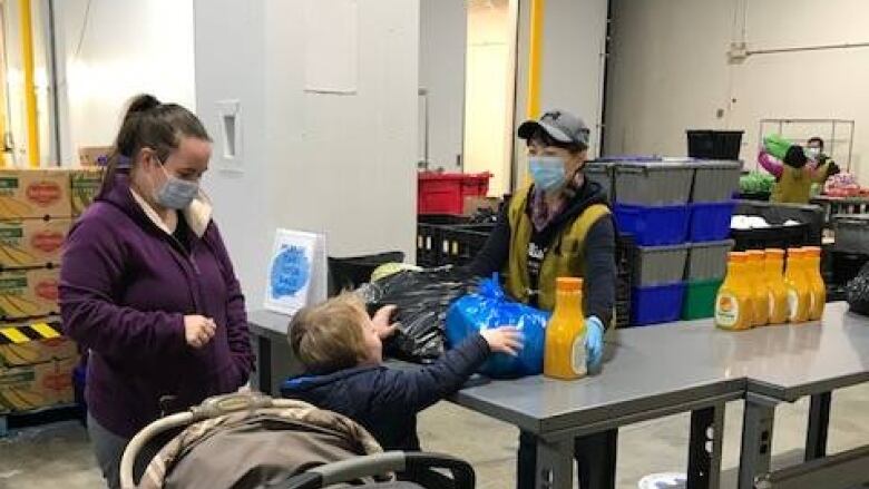 A woman and her child visit a food bank.