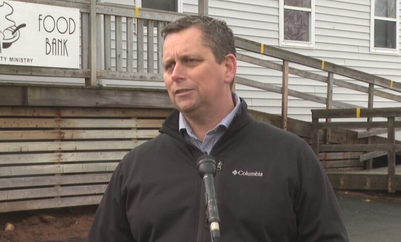 Mike MacDonald stands in front of Upper Room food bank 