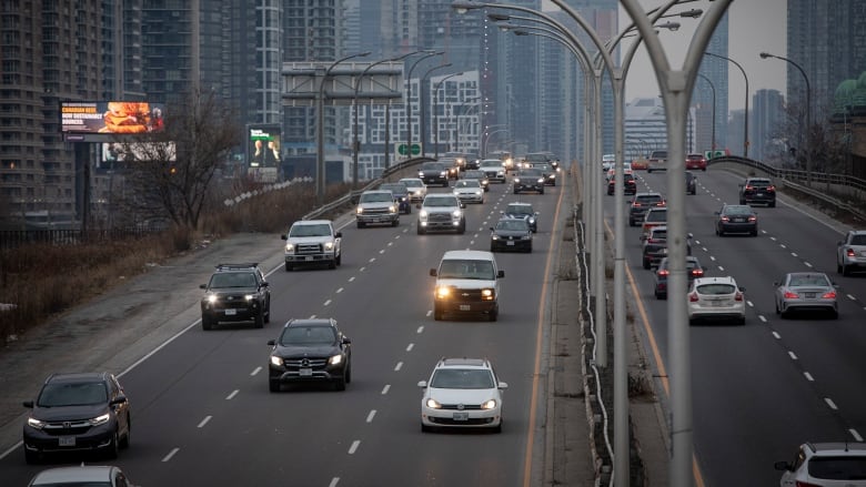 Cars drive on an expressway.