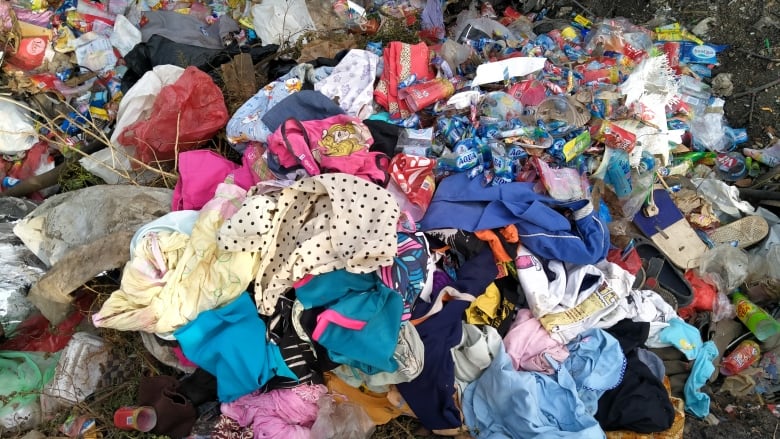 A bunch of discarded clothes of various shapes and colours.