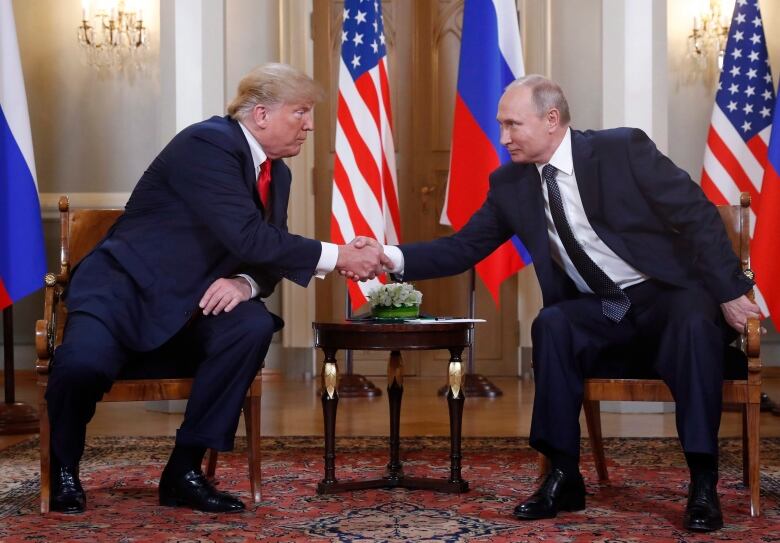 U.S. President Donald Trump, left, and Russian President Vladimir Putin shake hand at the beginning of a meeting at the Presidential Palace in Helsinki, Finland, Monday, July 16, 2018. (AP Photo/Pablo Martinez Monsivais)