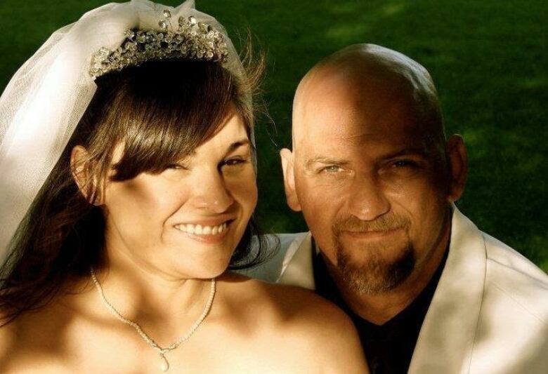 A bride and groom sit together.