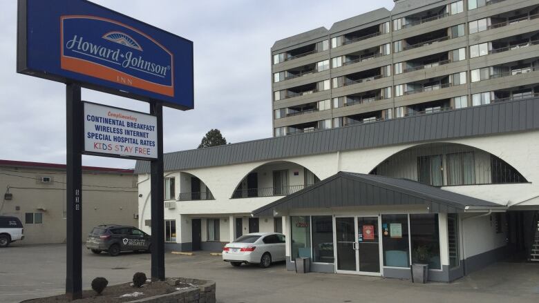 A motel with the words 'Howard Johnson' on a large sign outside.