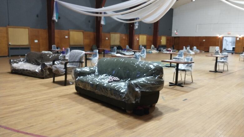 Couches and tables in a gynmasium space serve as a warming centre.