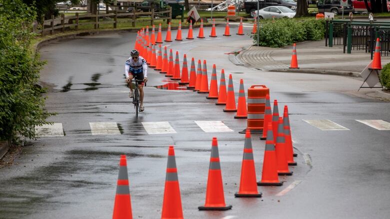 Cyclists and cars share the road through Stanley Park in Vancouver, British Columbia, on Tuesday, June 23, 2020. The short-term future of the dedicated bike lane in the park is on the table at a city park board meeting Monday.