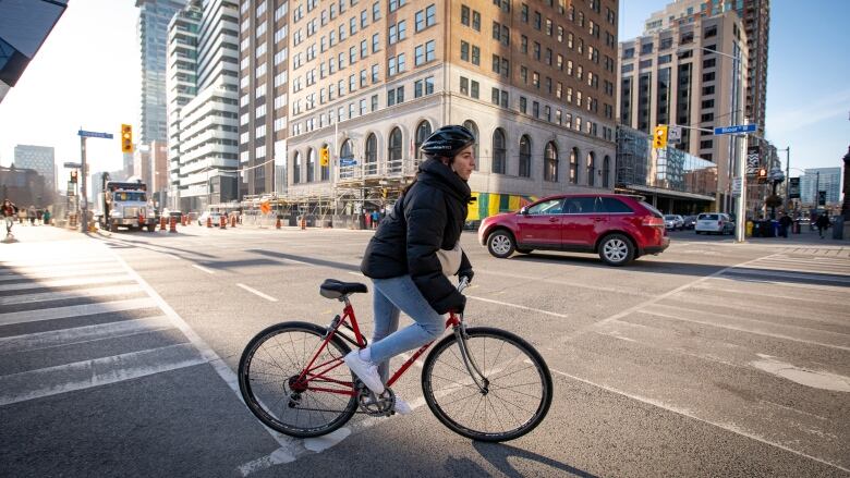 Cyclists and pedestrians cross paths along Torontos Bloor St. bike lane on March 9, 2021. 