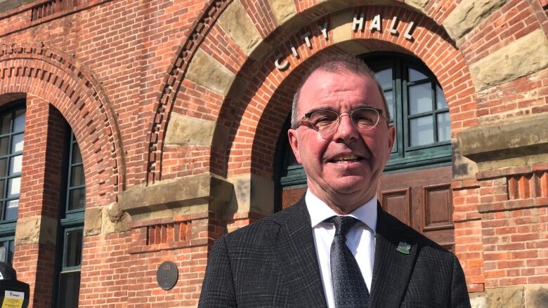 Charlottetown Mayor Philip Brown in front of city hall on a sunny day.