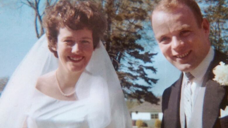 A smiling bride and groom.