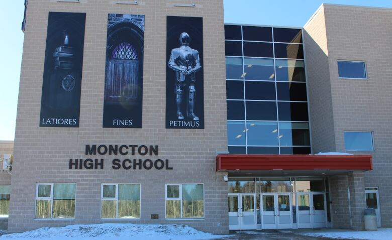 The front of a grey stone building is shown.