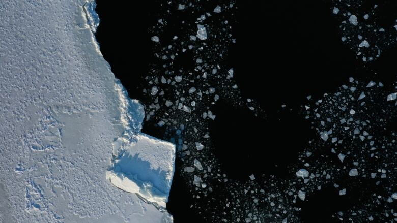 A chunk of sea ice is shown floating in the ocean. 