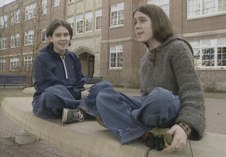 Musicians Tegan and Sara Quin sit outside their Calgary high school in 1998.