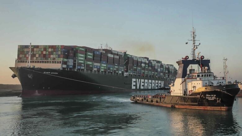 The Ever Given, a Panama-flagged cargo ship is pulled by one of the Suez Canal tugboats, after it got stuck in the Suez Canal