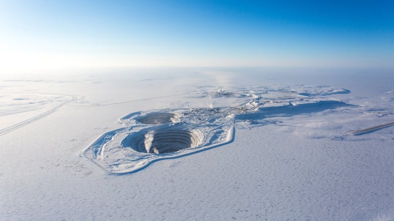 Aerial photo of snow, ripples, hole.