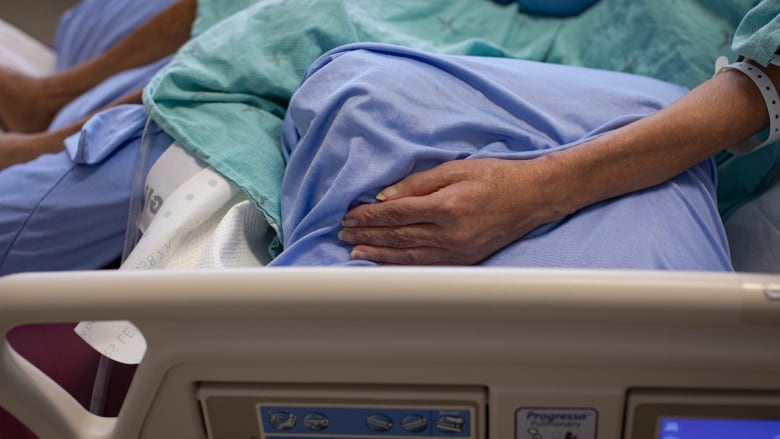 A patient recovering from COVID-19 is pictured in the intensive care uniT.