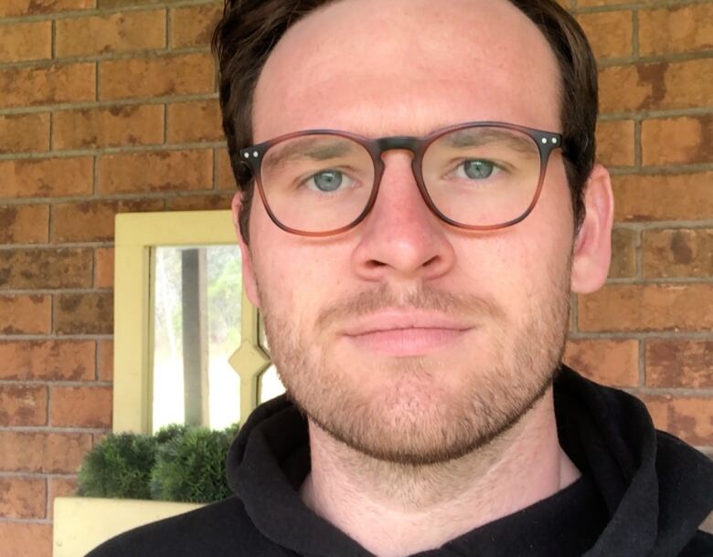 A young man with glasses.