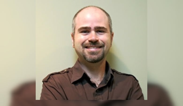 A Man in a brown shirt.