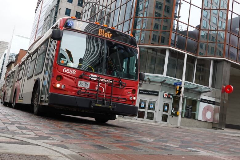 A red number 12 Blair bus drives through an intersection